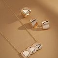 Celeste Pendant Necklace styled in a trio with matching earrings and rings