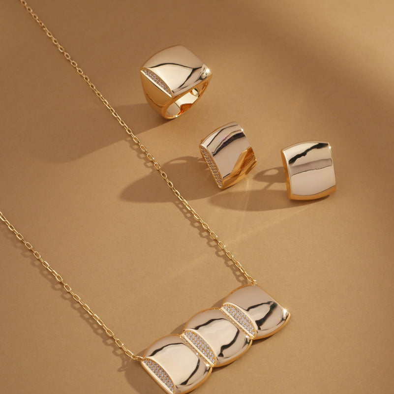 Celeste Pendant Necklace styled in a trio with matching earrings and rings