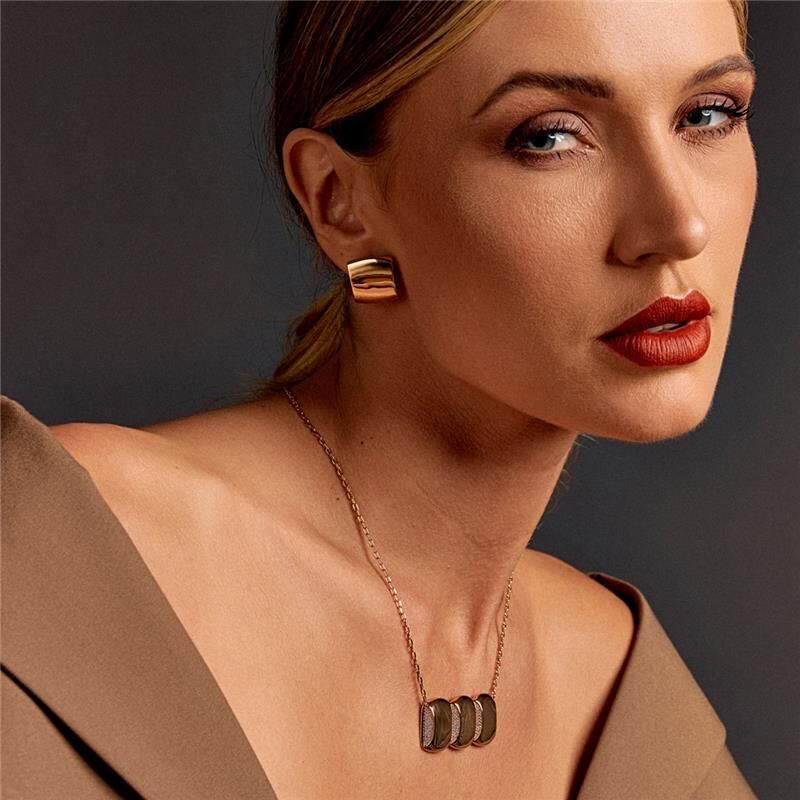 Model wearing Celeste Pendant Necklace with elegant styling and bold red lipstick