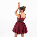 Model wearing Galli The Label Bubble Mini Dress in burgundy with square neckline and playful bubble hem