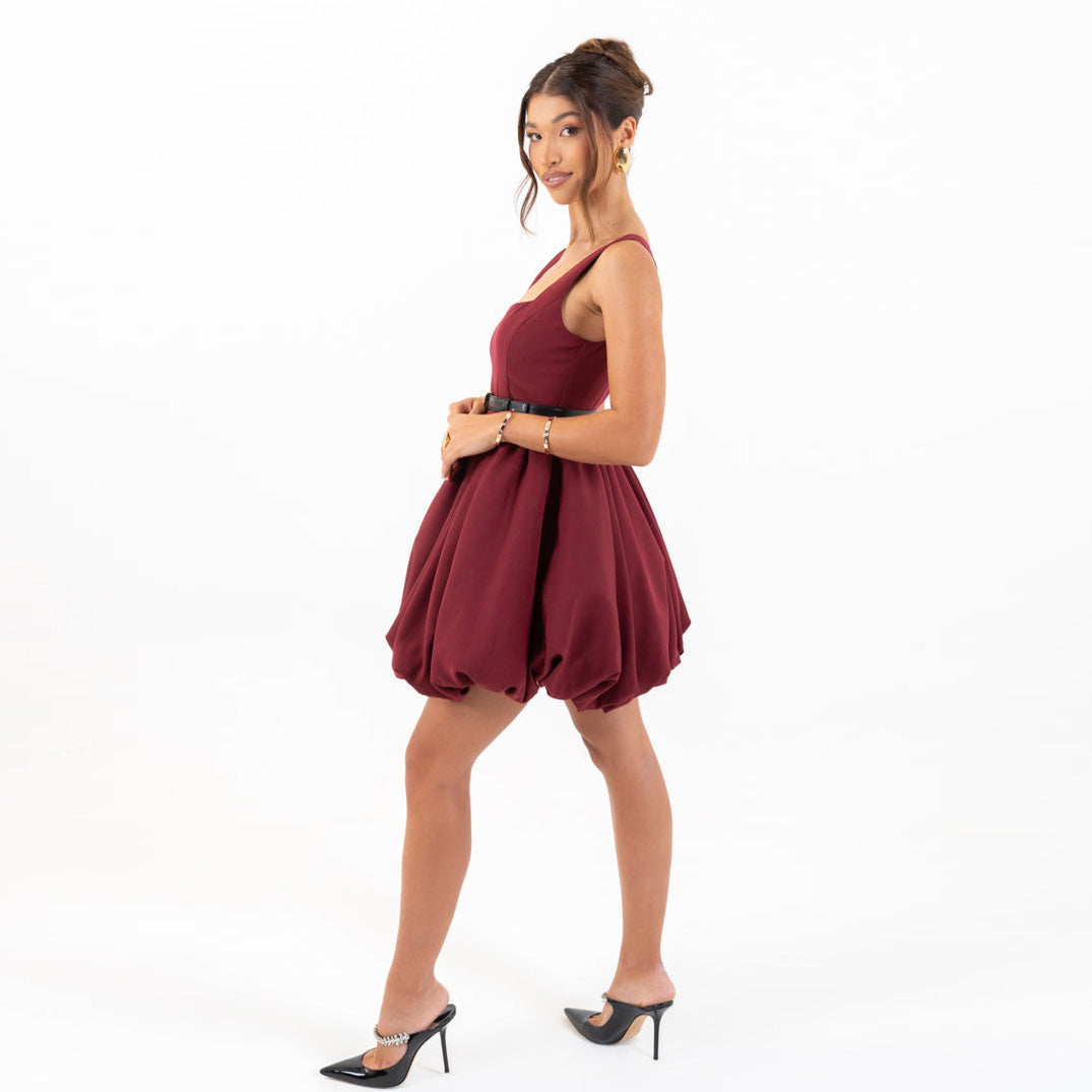 Model wearing Galli The Label Bubble Mini Dress in burgundy with square neckline and playful bubble hem.