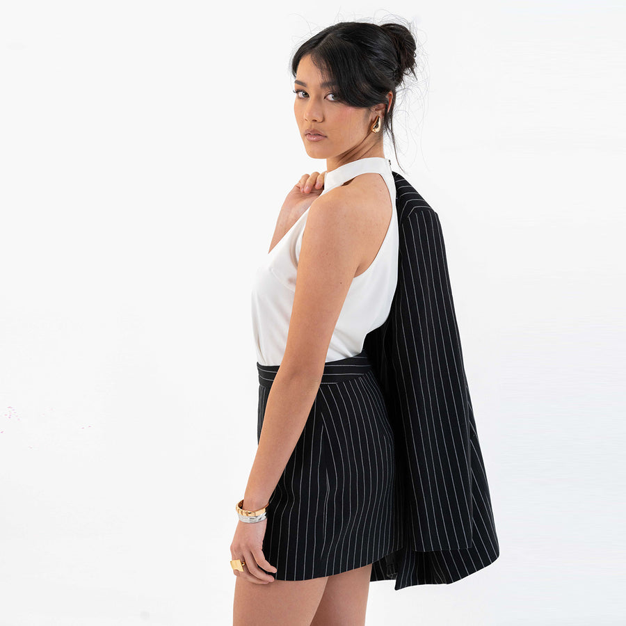 Close-up of Pinstripe Power Set showing layered pearl necklace and bracelet.