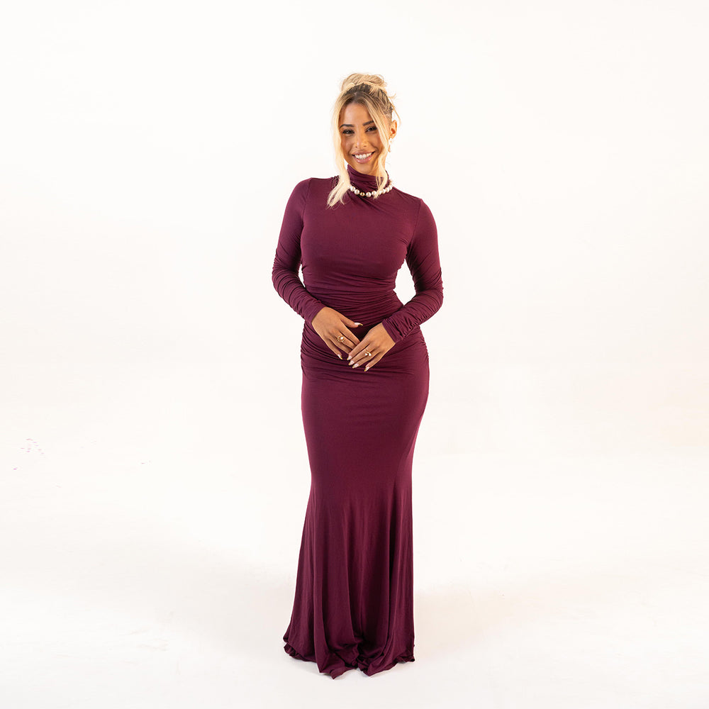Model wearing Plum Curve Dress front view with high neckline and ruched design
