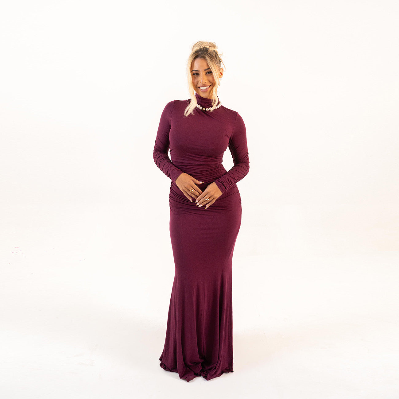 Model wearing Plum Curve Dress front view with high neckline and ruched design