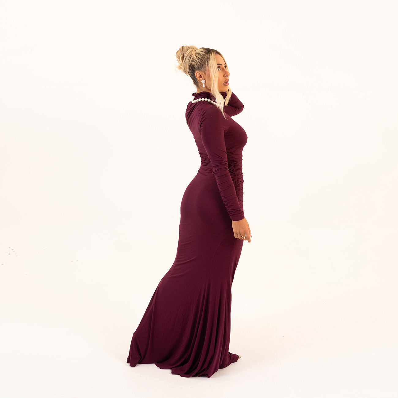Side profile of Plum Curve Dress showing flattering floor-length silhouette