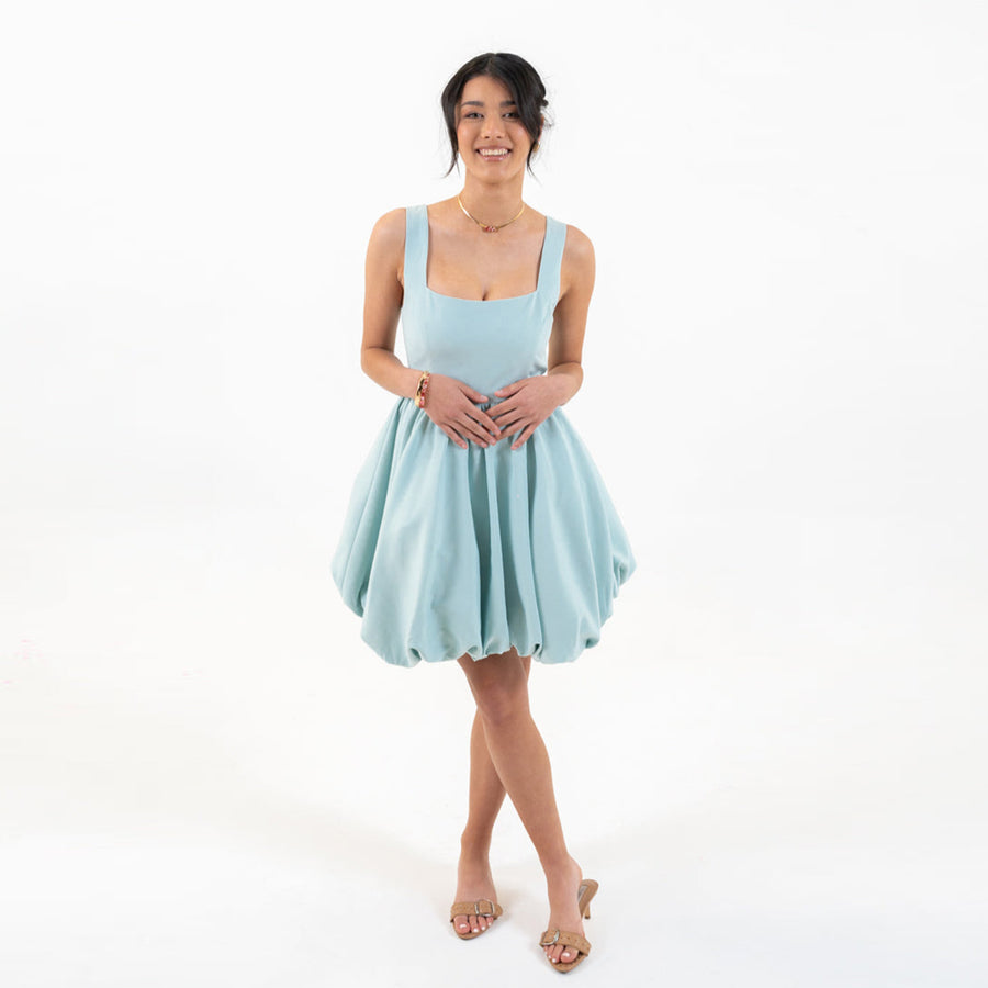 Model wearing Skyfall Mini Dress front view showing light blue bubble hem design.