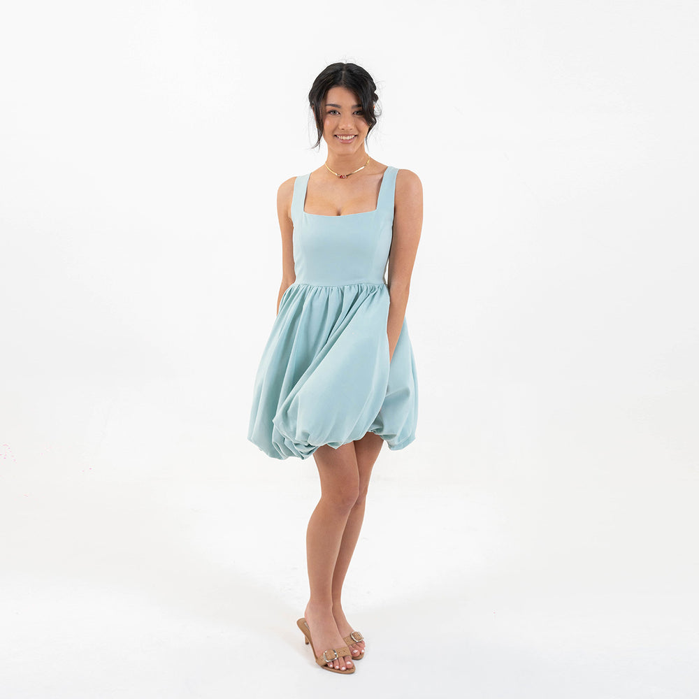 
                  
                    Model side profile wearing Skyfall Mini Dress showing voluminous skirt detail
                  
                