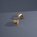 Golden Curve Piercing displayed on blue background