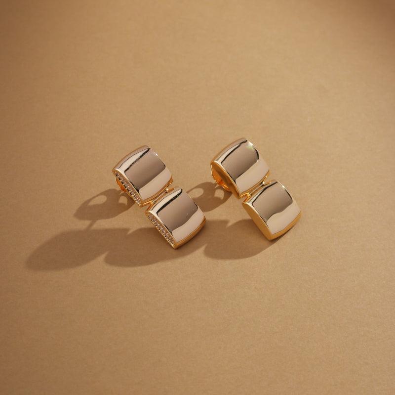 
                  
                    Close-up of Golden Halo Earrings under warm lighting showing zirconia detail
                  
                