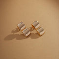 Close-up of Golden Halo Earrings under warm lighting showing zirconia detail
