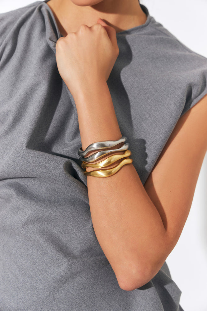 Model wearing multiple Halo Dome Bracelets on wrist