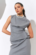 Model posing in sleeveless grey dress wearing gold-plated hoop pearl necklace