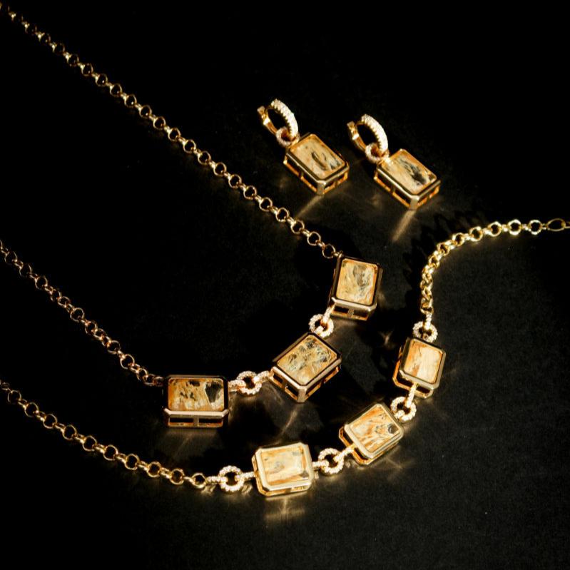 Lyra Bar Bracelet styled with layered gold jewelry crystal pendant detail