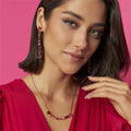 Model wearing Rose Pendulum Drop Earrings with pink outfit