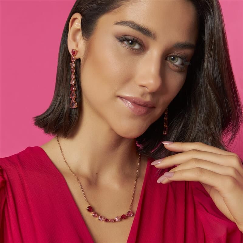 Model wearing Rose Pendulum Drop Earrings with pink outfit