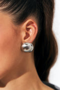 Satin Sphere Studs in silver worn on model's ear