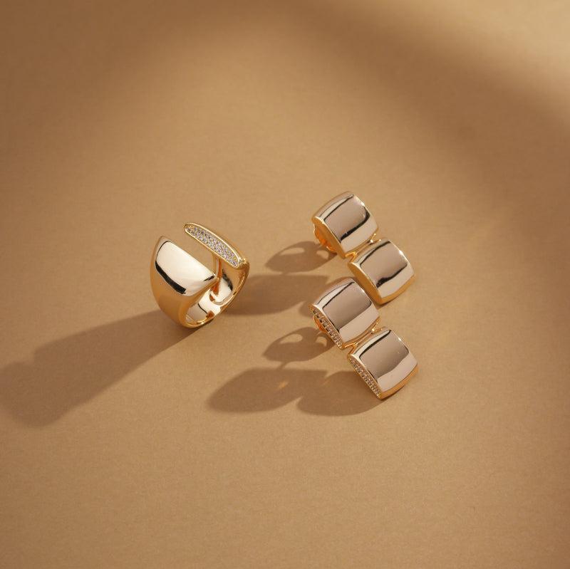 Solstice Ring in gold with zirconia detail displayed on neutral surface