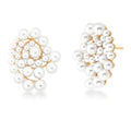 Spiral pearl drop earrings with white gold finish on white background