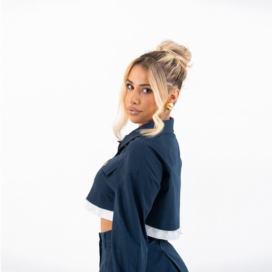 Close-up of model in camel jacket, showing lapels and buttons