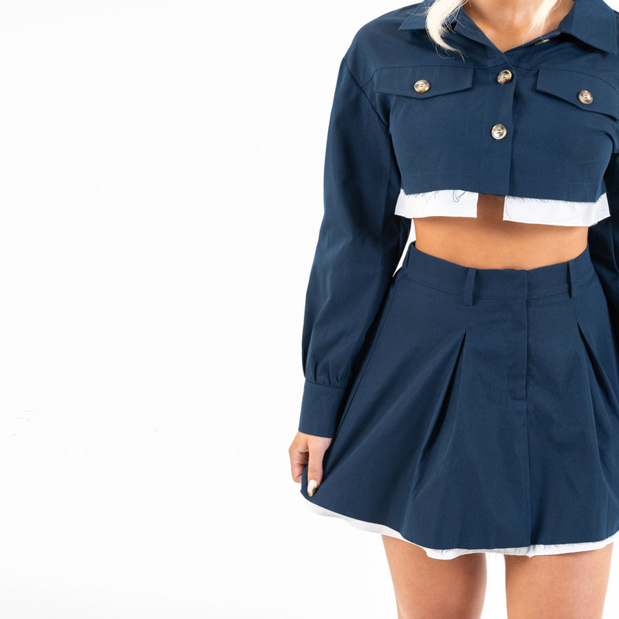 Close-up of navy set’s cropped jacket and buttons