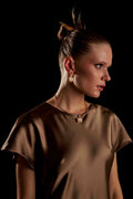 Model wearing Vega Drop Earrings gold plated earrings side profile view
