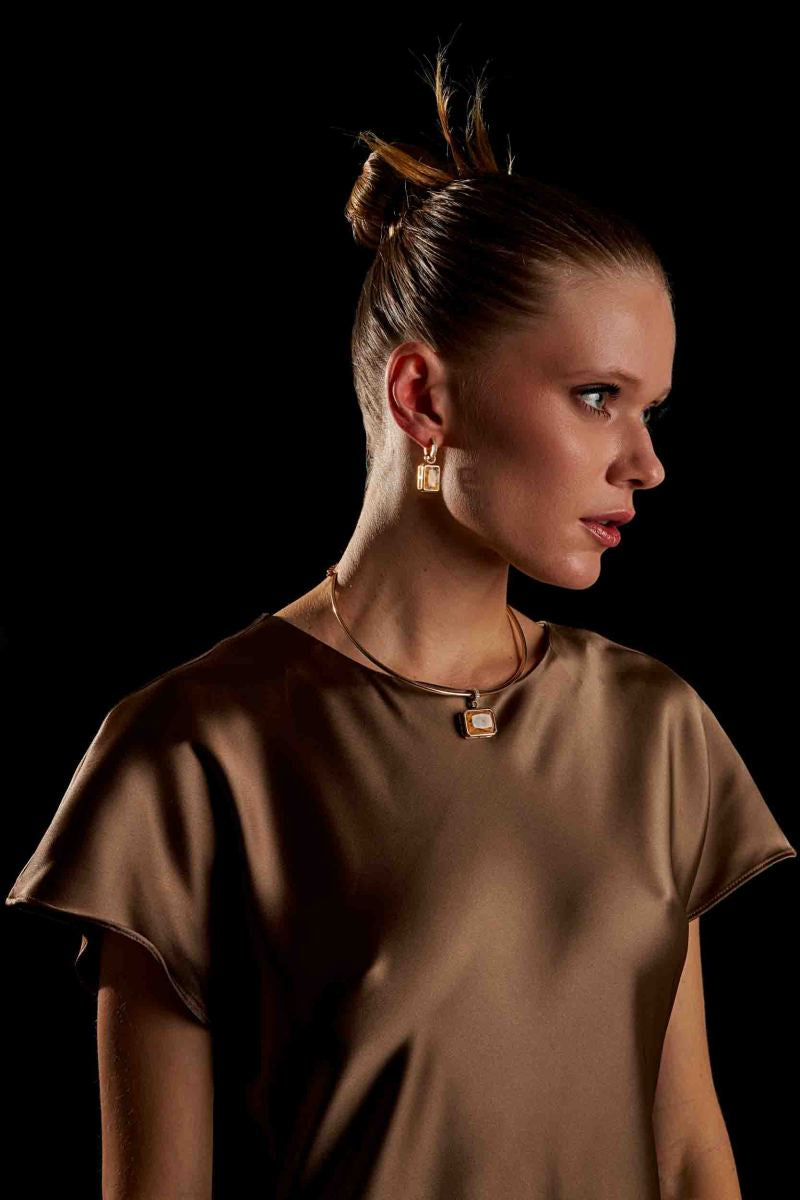 Model wearing Vega Drop Earrings gold plated earrings side profile view